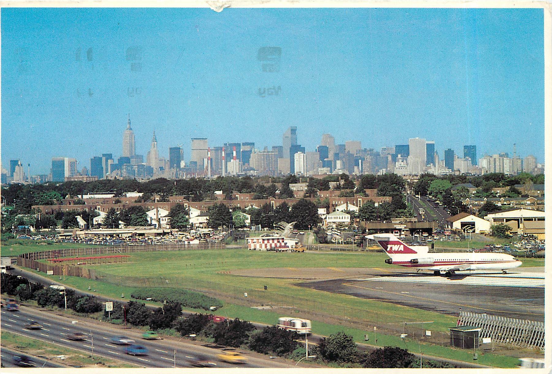 CPM Close in La Guardia Airport The Grand Central Parkway is in the foreground Manhattans Skyline is