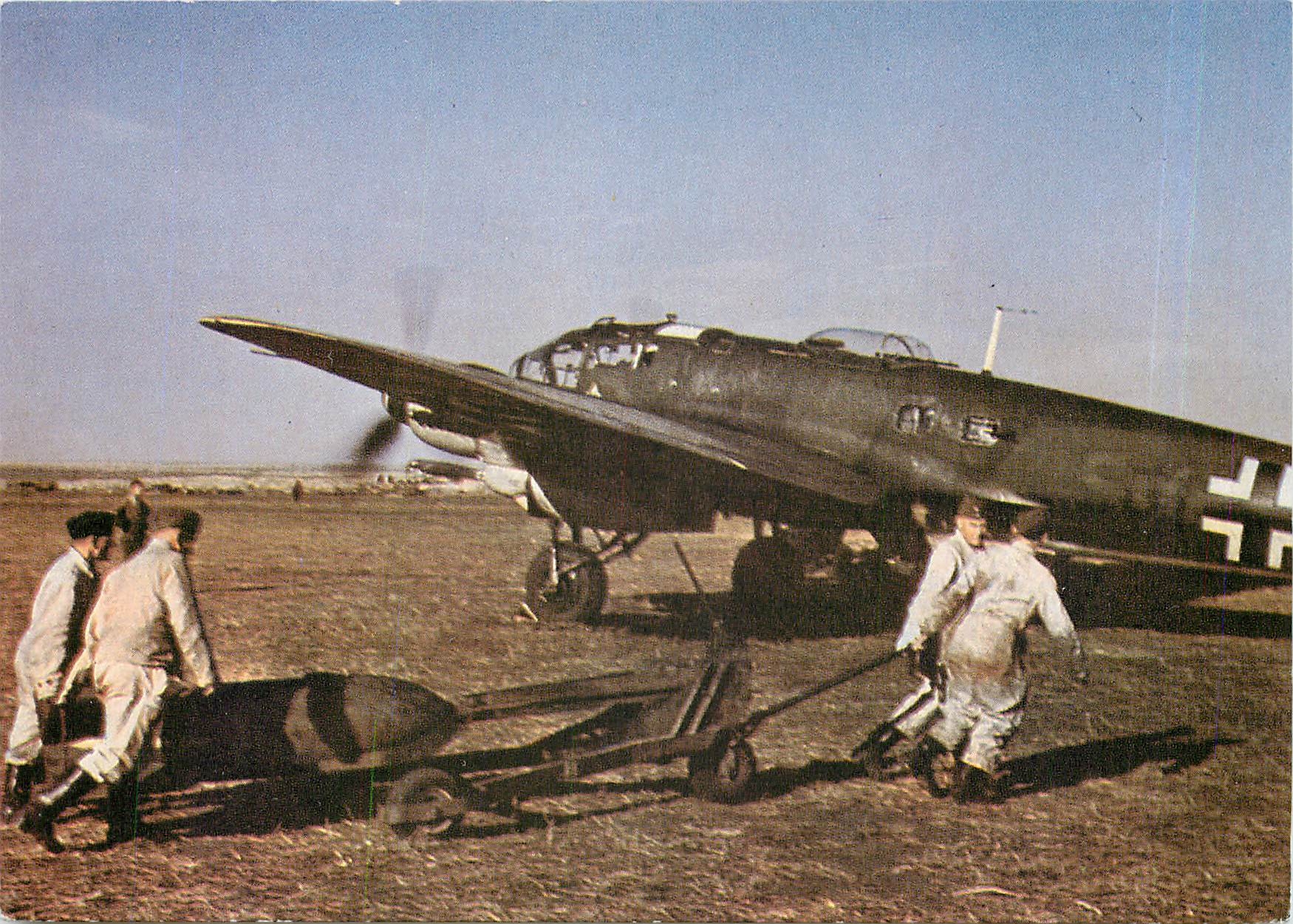 CPM An SC 500 bomb is manhandled into position beside a Heinkel He 111H 6 of KG55 on the Eastern Fro