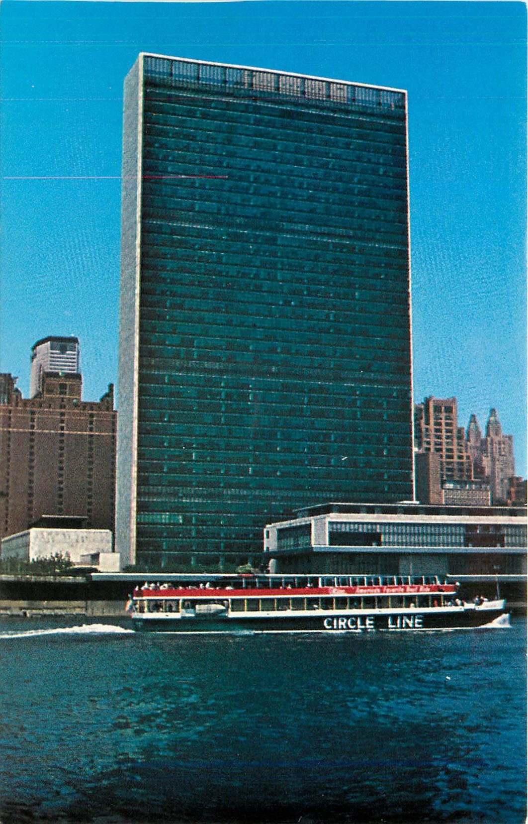 CPM East River view showing a Circle Line yacht with the United Nations Headquarters in the backgrou
