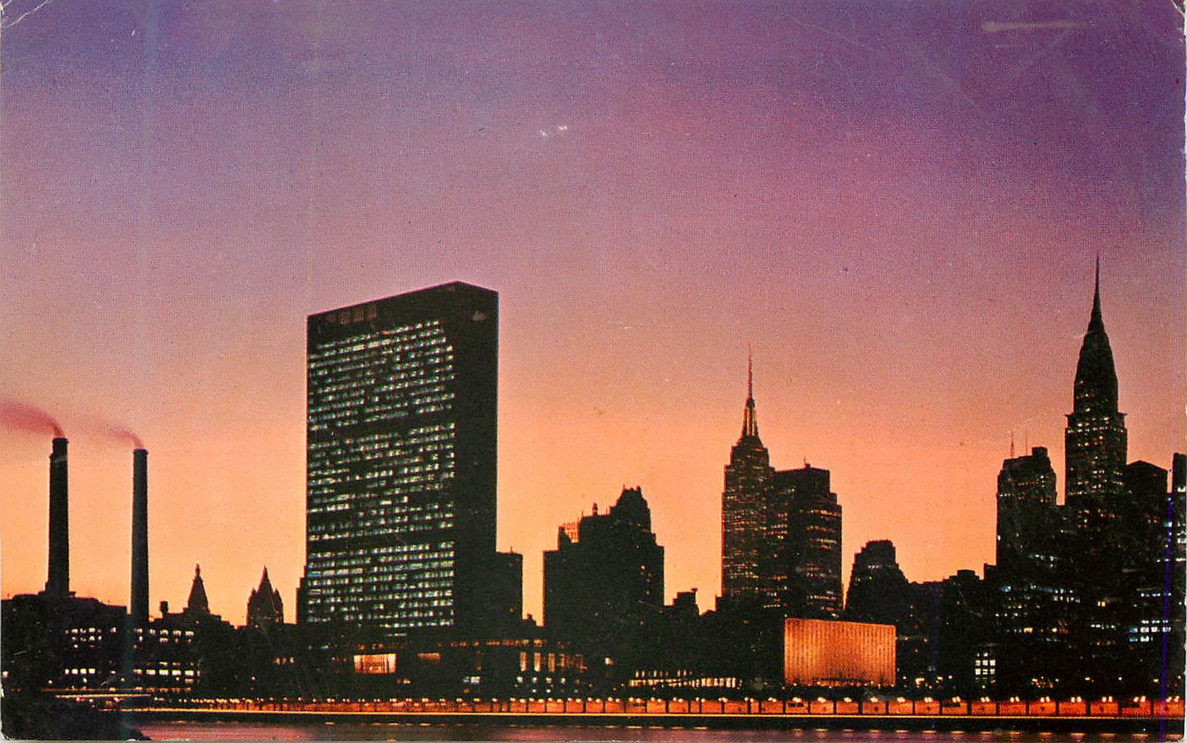 CPM United Nations Building at Night Wiht Empire State Building at Left and Crysler Buildingat Right New York City