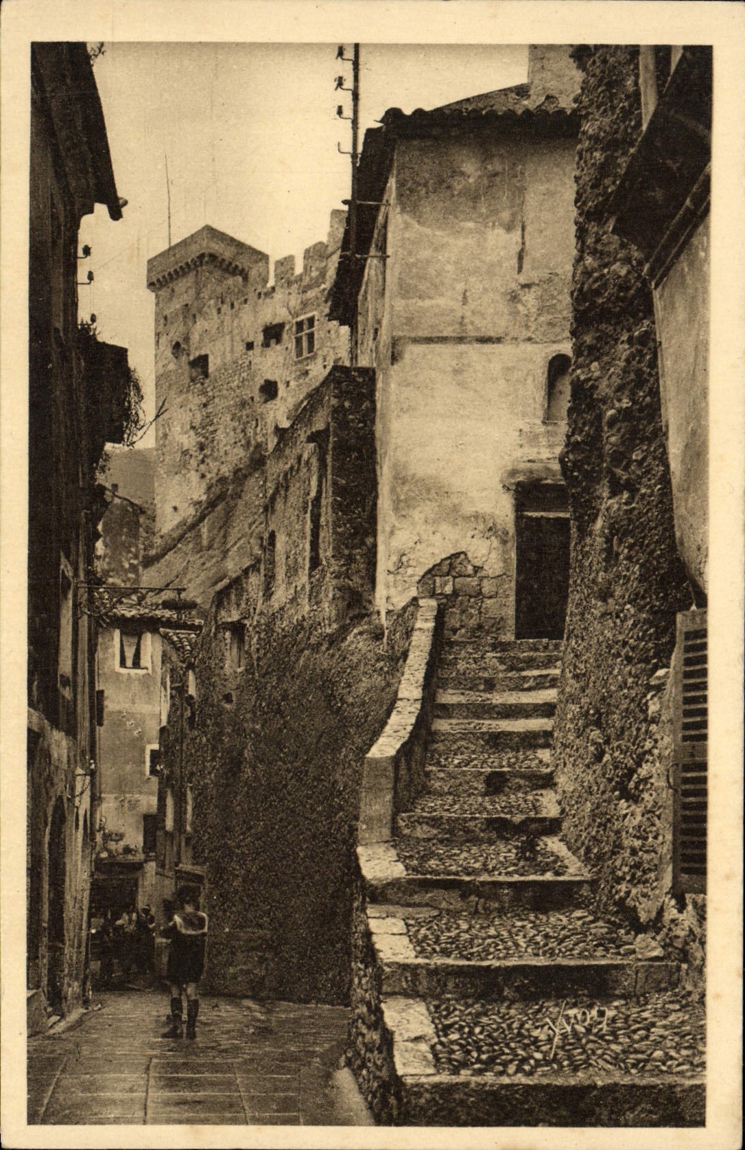 VINTAGE POSTCARD Roquebrune Old woman street dominee by the Fort