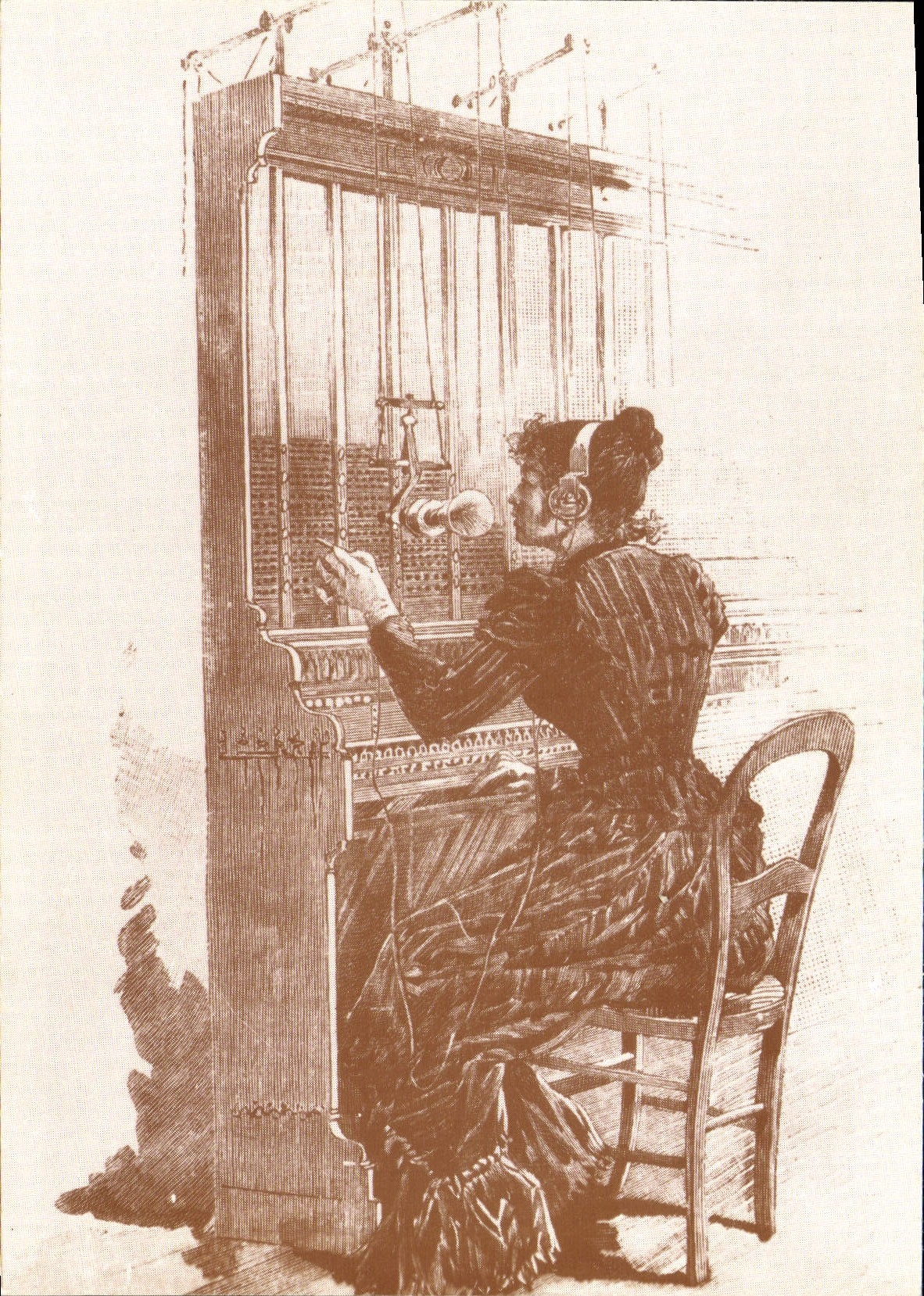 MODERN CARD Standardiste Sitting In front of a multiple Boilard System Telephones