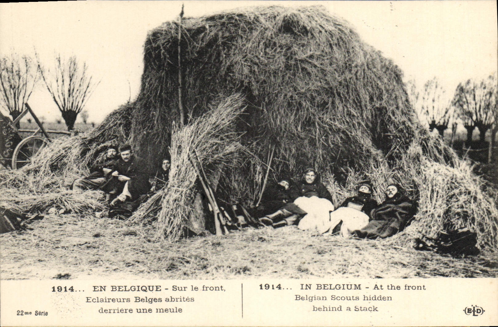 VINTAGE POSTCARD Belgian Eclaireurs shelter behind a Militaria grinding stone