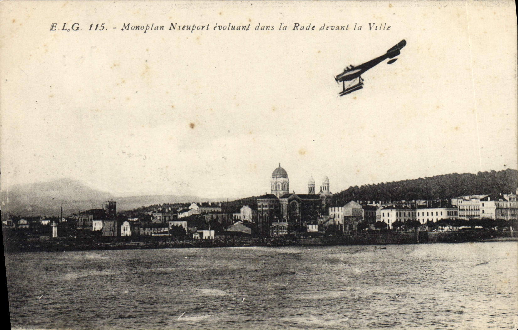 VINTAGE POSTCARD Plane Aviation Nieuport Monoplane evolving/moving in the roads in front of the city