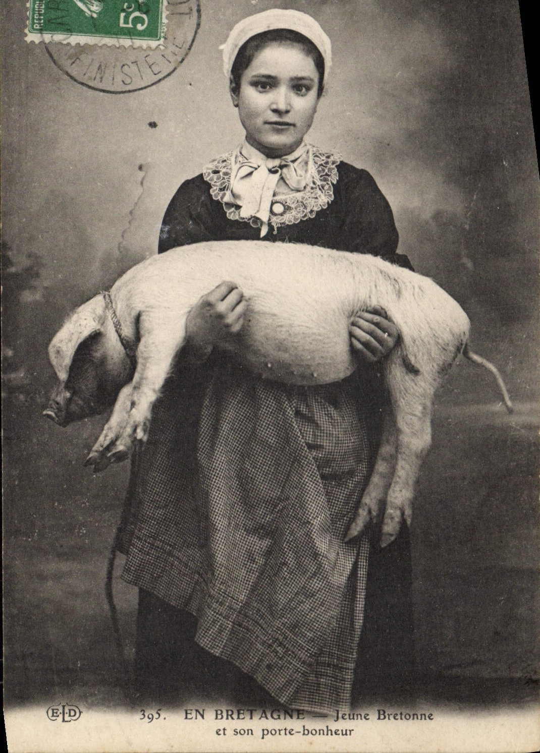 Folklore de la POSTAL de la VENDIMIA en Bretaña joven bretona y su cerdo del cerdo de la felicidad de la puerta