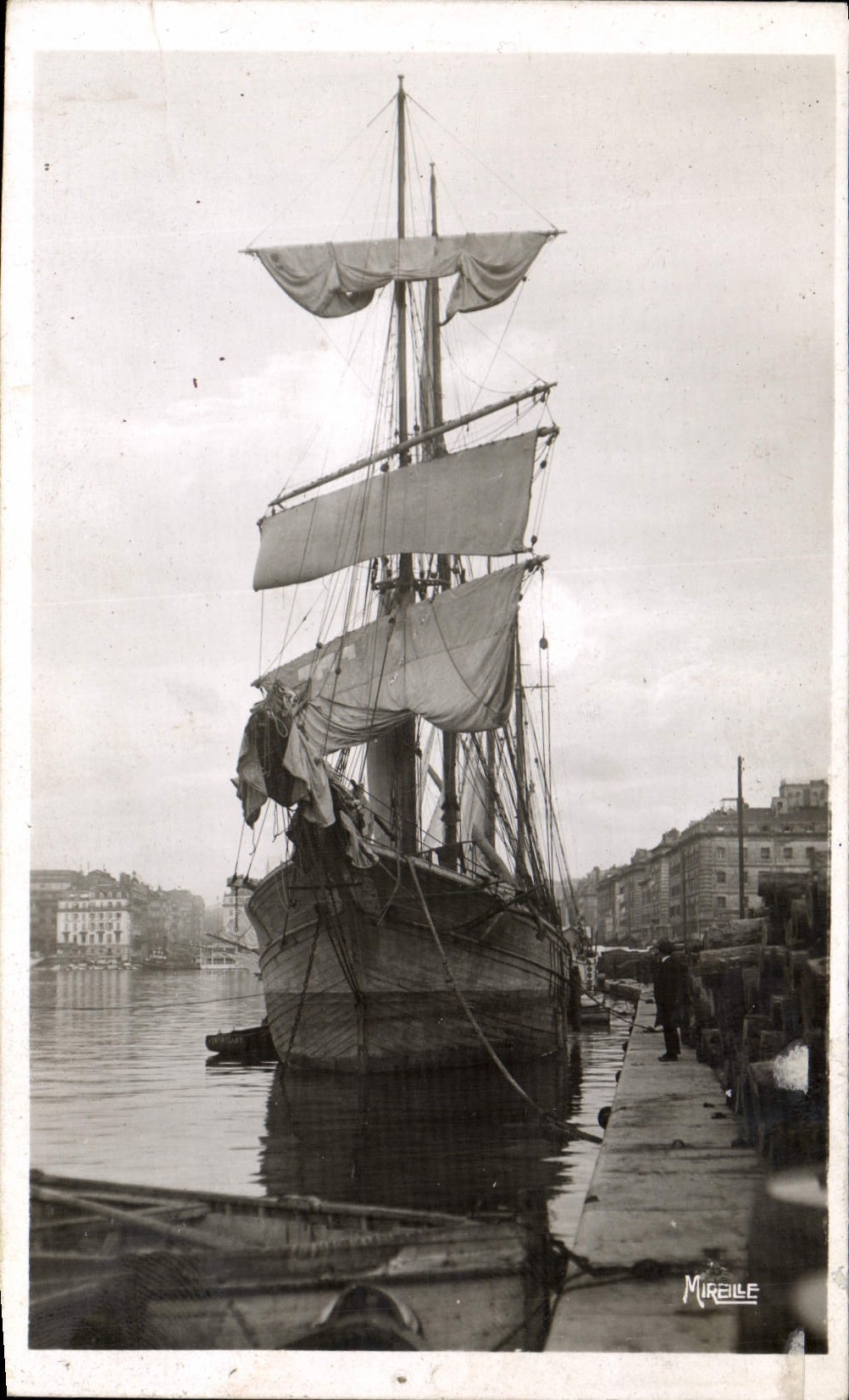 VINTAGE POSTCARD Marseilles Boat a sailing ship in the viex port In the distance Canebiere