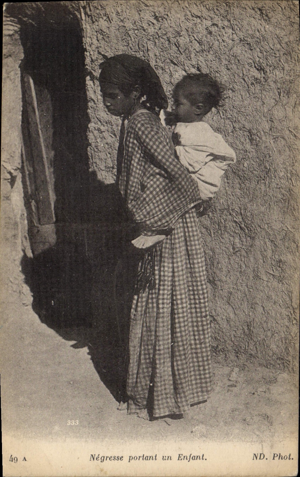 VINTAGE POSTCARD Negro black Woman Negress carrying a child