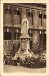 CPA La statue de Ste Therese de l'Enfant Jesus pres de la Chapelle du Carmel de Lisieux 
