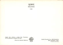 CPM Cable Car climbs a steep San Francisco hill as sailboats navigate the bay 