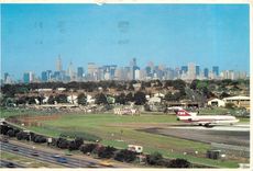 CPM Close in La Guardia Airport The Grand Central Parkway is in the foreground Manhattans Skyline is