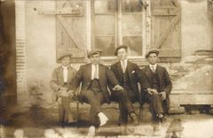 Real photo Men on a bench (folklore costume caps)