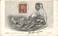 VINTAGE POSTCARD Tunisia a Bedouin with a child