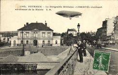 VINTAGE POSTCARD Puteaux the Military Airship Freedom evolving/moving with the top of the Town hall Zeppelin