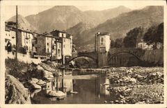 VINTAGE POSTCARD Sospel Old woman Houses at the edge of Bevera